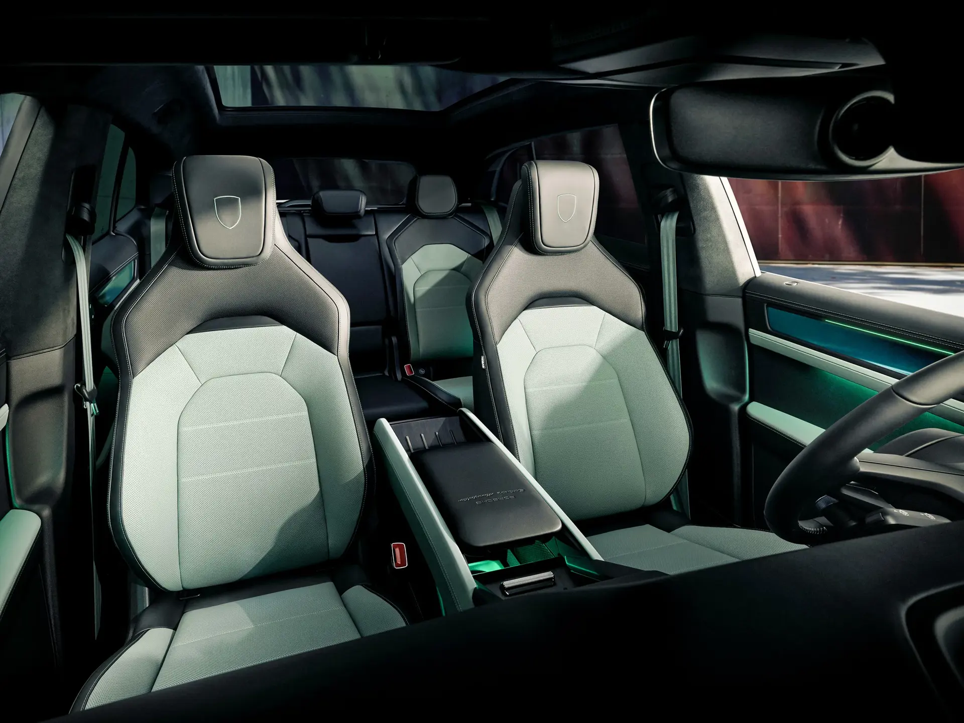 Moderne SUV-interiør med lyse sportssæder, panorama-glastag og oplyste detaljer i dørsider og midterkonsol.